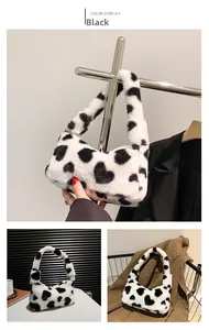Close-up of soft faux fur handbag featuring black and white heart-shaped cow pattern