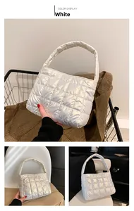 Close-up of quilted white puffer handbag with soft handle and elegant grid pattern details