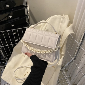 Beige quilted crossbody bag with chunky chain detail and detachable shoulder strap
