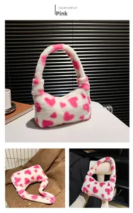 Detail of soft white faux fur handbag featuring a pink heart print and shoulder strap
