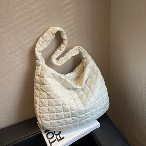 White quilted puffy cloud shoulder bag with spacious padded design and zipper closure