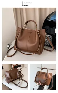 Detail view of large brown vintage tote bag with gold hardware and detachable strap