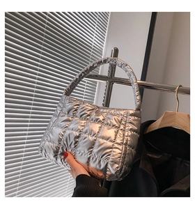 Detailed view of silver quilted tote bag with metallic waterproof fabric and padded handle