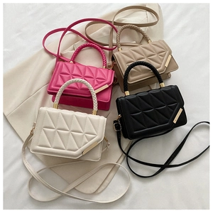 Top view of four quilted PU leather handbags with braided handles and gold metal accents