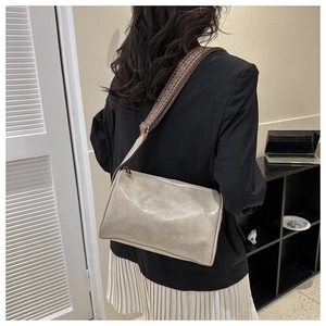 Chic beige crossbody bag with bohemian patterned wide strap shown from a back-view perspective