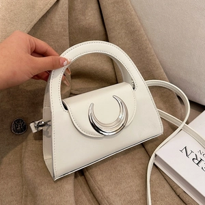 Minimalist white leather crossbody handbag with elegant silver crescent metal clasp