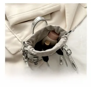 Interior view showing the capacity of a silver crocodile pattern mini bucket bag