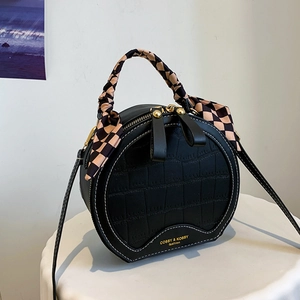Fashionable black crocodile embossed round handbag with silk scarf handle and gold logo