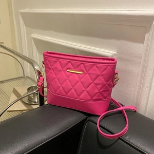 Rose red quilted crossbody bag with gold chain hardware and sleek faux leather finish