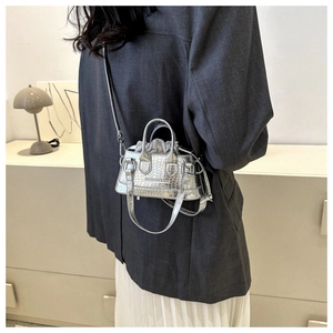 Detail of silver crocodile pattern mini crossbody bag with drawstring inner pouch