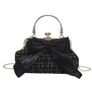 Elegant black tweed shoulder bag with large satin bow and cherry-shaped gold clasp lock