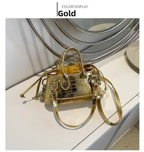 Close-up of golden mini handbag with crocodile texture and yellow drawstring liner