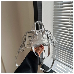 Silver crocodile-textured handbag with metallic finish and drawstring inner bag details