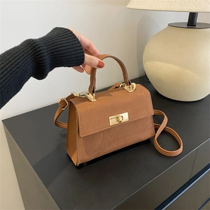 Brown crocodile embossed square handbag with gold twist lock and top handle