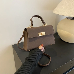 Deep brown croc-embossed small square handbag with golden twist lock and shoulder strap