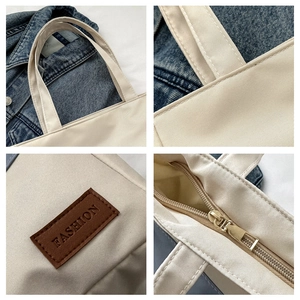 Detail view of Oxford fabric tote bag showing durable stitching, zipper, and fashion patch