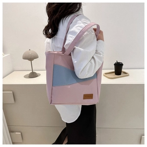 Detail of pink and light blue patchwork oxford tote bag with leather fashion tag
