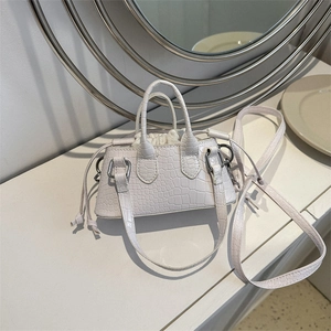 Mini cream faux crocodile leather crossbody bag with elegant top handles and drawstring pouch