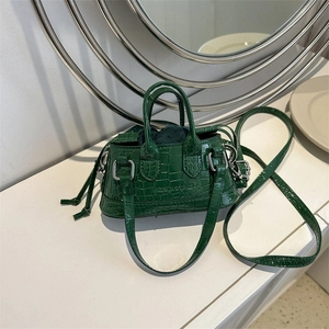 Chic green crocodile embossed mini handbag with top handles and cross-body strap