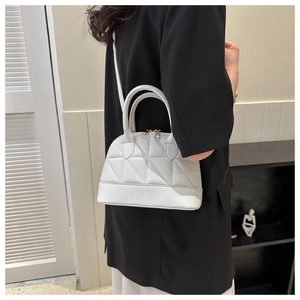 Chic white quilted crossbody bag with triangle stitching and gold zipper detail