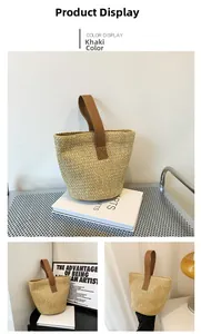 Detailed straw bucket bag texture with brown leather handles and reinforced X-stitching
