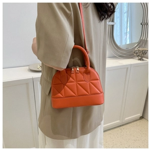 Quilted brick red top handle shell bag with double zipper and gold hardware