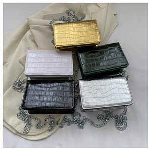 Close-up of stone pattern square bags with chain straps in five elegant color options