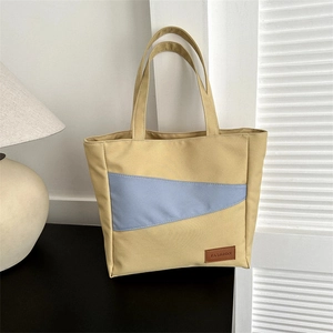 Minimalist beige oxford canvas tote bag with blue contrast stripe and fashion label