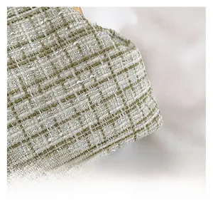 Detailed close-up of premium tweed fabric with green and beige woven check pattern