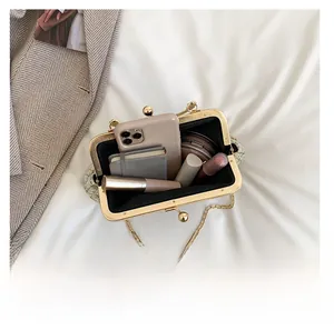 Interior view of green woven shell bag showing capacity for phone and cosmetics