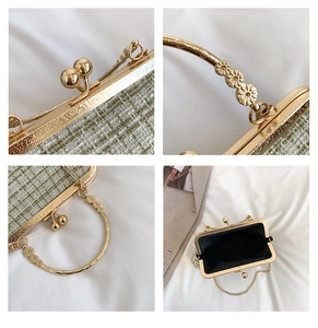Close-up of green tweed bag showing vintage gold floral handle and embossed metal frame