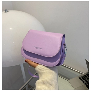 Detail of lavender saddle bag showing the engraved text and high-quality PU leather