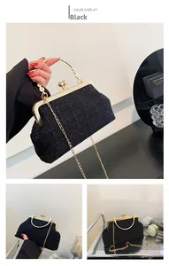 Close-up of black tweed texture and gold ring handle on a retro shoulder bag
