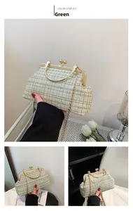 Detail of green and beige tweed bag with golden kiss-lock and ornate metal handle