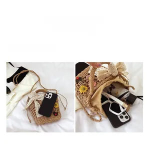 Detail view of the beige woven straw bag interior capacity with sunglasses and phone
