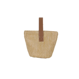 Minimalist straw bucket bag with brown leather handles and natural woven texture