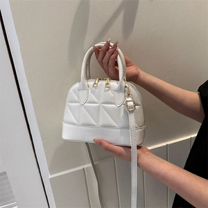 Chic white quilted crossbody handbag with gold hardware and top handle for women