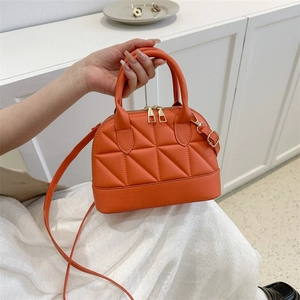 Chic orange quilted handbag with diamond lattice pattern and golden hardware strap