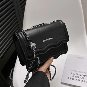 Black vintage leather crossbody bag with wave flap, silver chain and metal ball charm