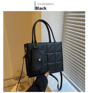 Detail of black quilted square handbag with geometric stitching and matching coin purse