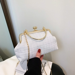 Elegant white tweed evening bag with vintage gold frame and chic chain strap