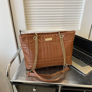 Brown quilted leather tote bag with gold chain strap and spacious commuter design
