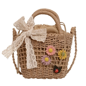 Handmade straw bucket bag with floral lace bow and adjustable strap for beach vacations