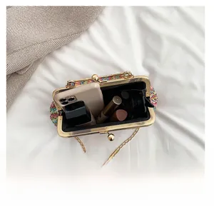 Top view of colorful woven handbag open showing spacious interior for phone and lipsticks