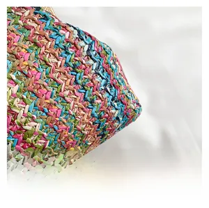 Detailed close-up of colorful handwoven straw fabric showing premium texture and pattern