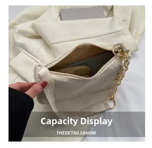 Capacity display of the beige fabric shoulder bag with golden chain and phone storage