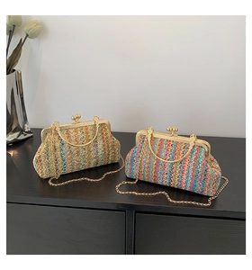 Detail of colorful chevron woven handbags with gold metal frame and chain strap