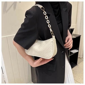 Detail of off-white shoulder bag with textured pattern and thick resin chain strap