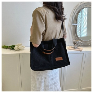 Versatile black corduroy tote bag with fashion leather patch for daily commuting use