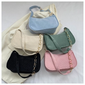 Close-up of quilted hobo shoulder bags with matching acrylic chain straps in five soft colors